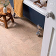 Bathroom with a blue bathtub and cream cork tiles
